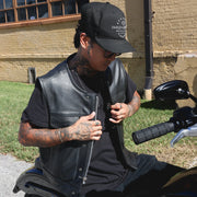  Made from cowhide leather, it includes four exterior pockets, two inside concealed carry pockets, a zip snap main closure, antique brass hardware, and a one-panel back, offering both style and functionality for various settings.