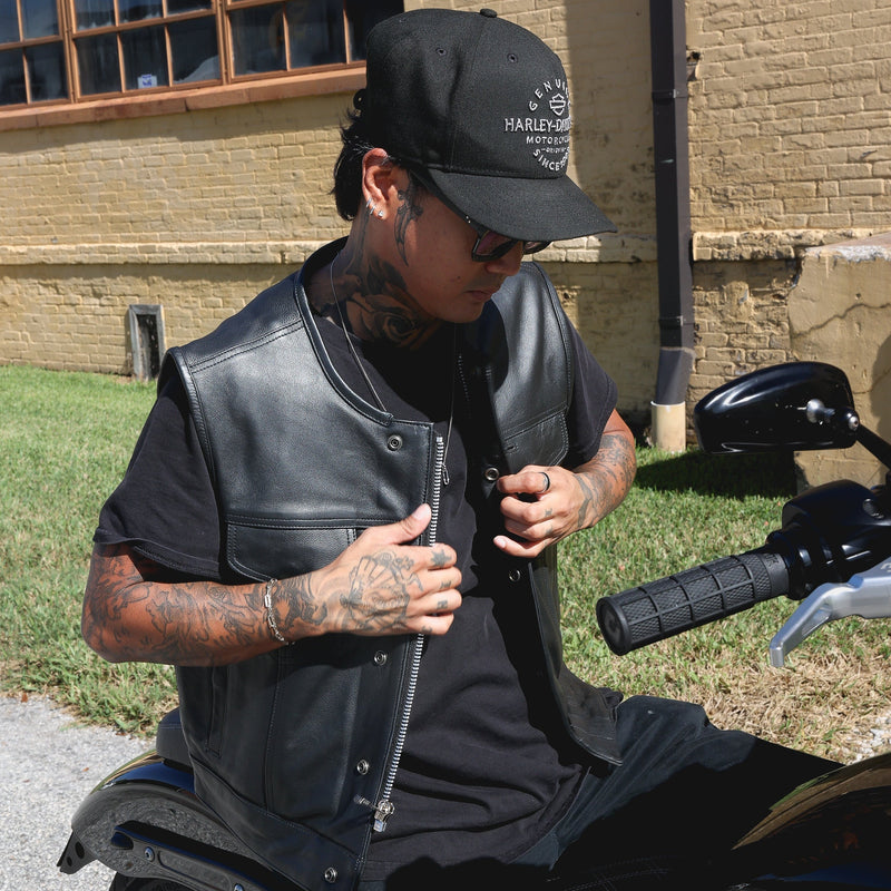  Made from cowhide leather, it includes four exterior pockets, two inside concealed carry pockets, a zip snap main closure, antique brass hardware, and a one-panel back, offering both style and functionality for various settings.