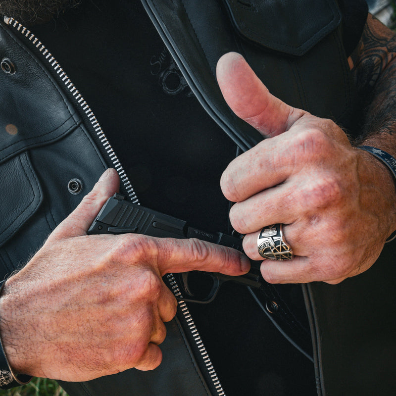  Made from cowhide leather, it includes four exterior pockets, two inside concealed carry pockets, a zip snap main closure, antique brass hardware, and a one-panel back, offering both style and functionality for various settings.