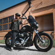  Made from cowhide leather, it includes four exterior pockets, two inside concealed carry pockets, a zip snap main closure, antique brass hardware, and a one-panel back, offering both style and functionality for various settings.