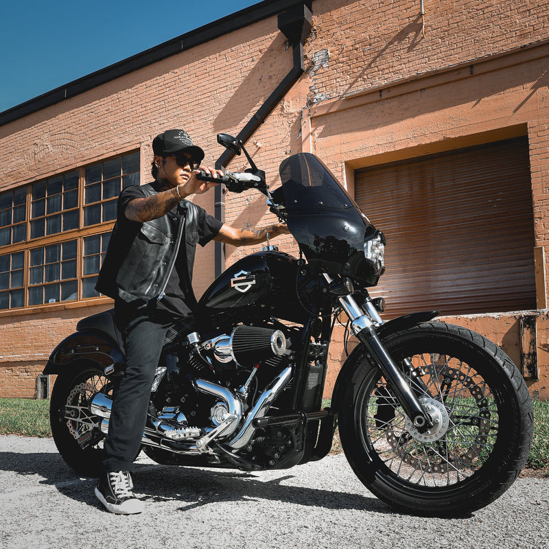  Made from cowhide leather, it includes four exterior pockets, two inside concealed carry pockets, a zip snap main closure, antique brass hardware, and a one-panel back, offering both style and functionality for various settings.