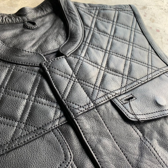 Made from cowhide leather with a diamond stitch pattern, it includes four exterior pockets, two inside concealed carry pockets, a zip snap main closure.