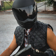 Made from cowhide leather with a diamond stitch pattern, it includes four exterior pockets, two inside concealed carry pockets, a zip snap main closure.