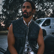 Made from cowhide leather with a diamond stitch pattern, it includes four exterior pockets, two inside concealed carry pockets, a zip snap main closure.