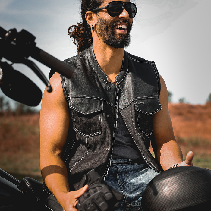  Featuring four exterior pockets, two inside concealed carry pockets, a zip snap main closure, antique brass hardware, and a one-panel back, this vest provides both practicality and unique aesthetic appeal.